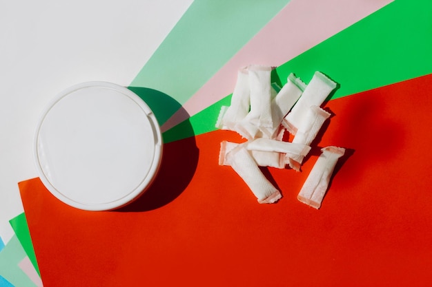 Snus can and portions on a colorful flat lay